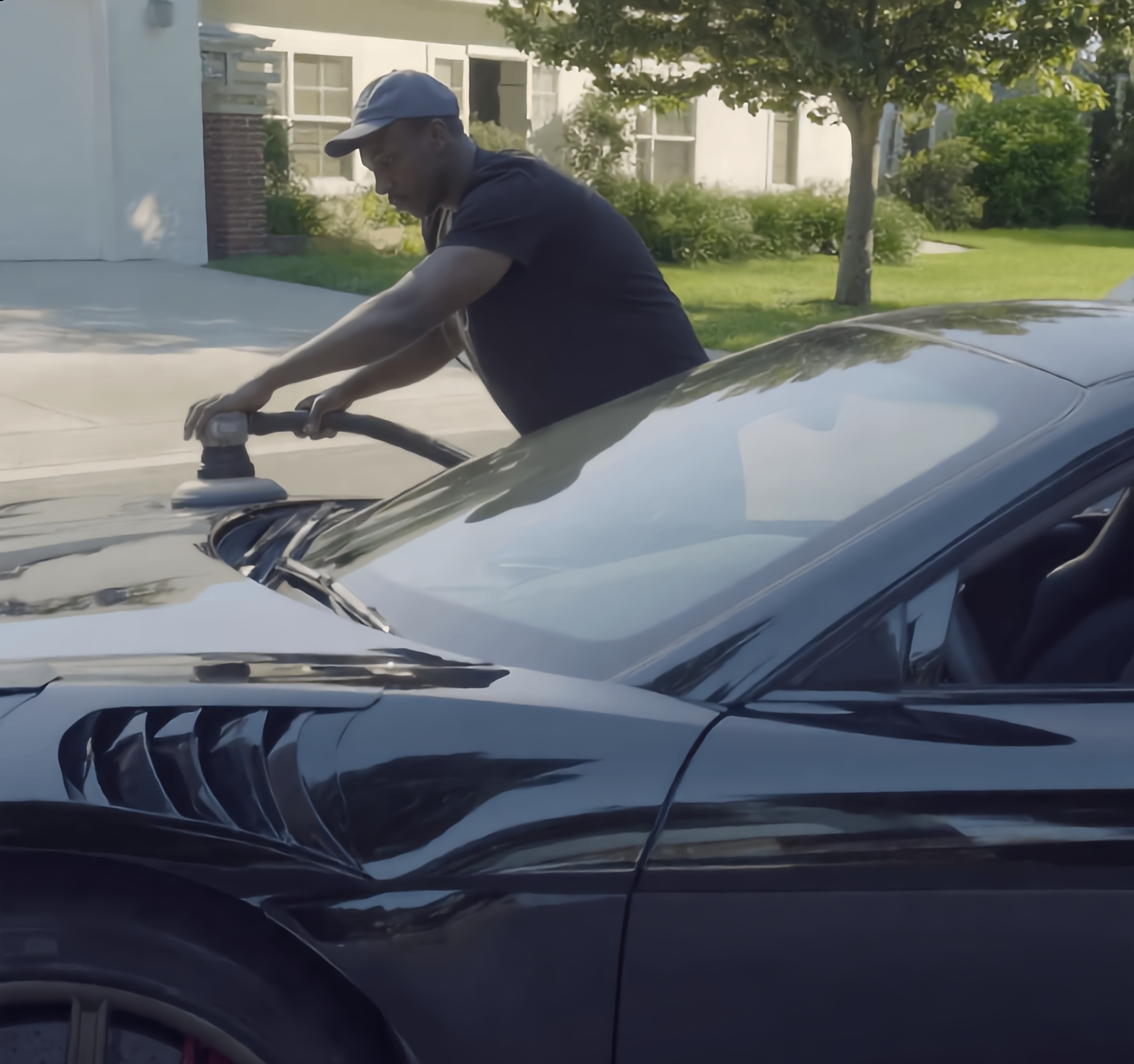 Flint detailer machine polishing a black sedan